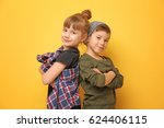 Cute stylish children on color background