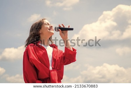 Cute and stylish. having a party. Happy kid with microphone. Singing Songs in karaoke. Lifestyle and People Concept. make your voice louder. Music and life. teen girl singing song with microphone