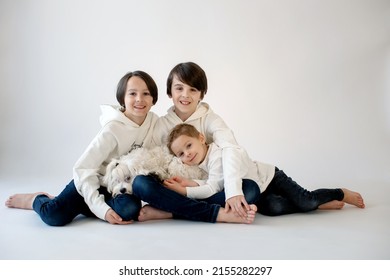 Cute Stylish Toddler Child And Older Brothers, Boys With White Shirts On White Background, Family Kids Portrait, Studio Shot