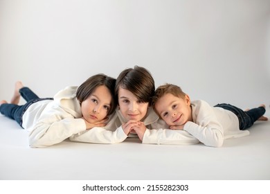 Cute Stylish Toddler Child And Older Brothers, Boys With White Shirts On White Background, Family Kids Portrait, Studio Shot