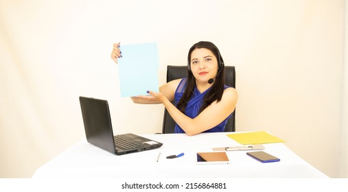 Cute And Successful Responsible CEO Asian Women, In A Blue Blouse, Showing Documents, Working Hard On A Laptop And Headset, On A White Background