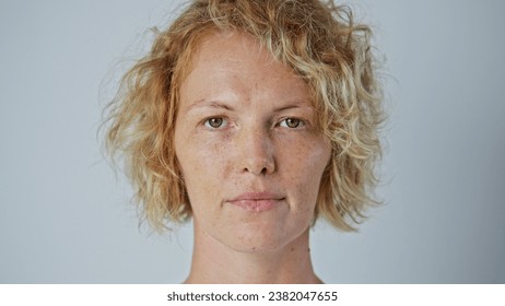 Cute sun kissed 30s woman look camera. Freckled girl face portrait. Irish young adult person. One 40s years old lady head shot. German skin care cream. Serious blond hair style. No make up life close. - Powered by Shutterstock