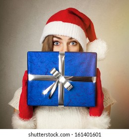 Cute Surprised Young Woman Holding Big Blue Present