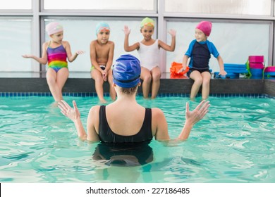 Cute swimming class watching the coach at the leisure center - Powered by Shutterstock