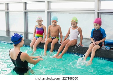 Cute swimming class watching the coach at the leisure center - Powered by Shutterstock