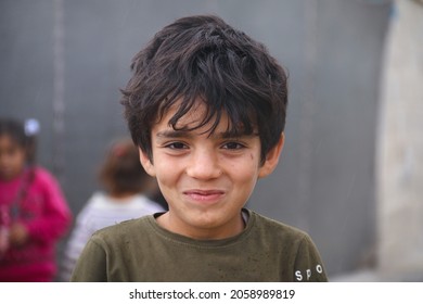 Cute Syrian Child In A Refugee Camp In The Rain.
Aleppo, Syria October 17, 2021