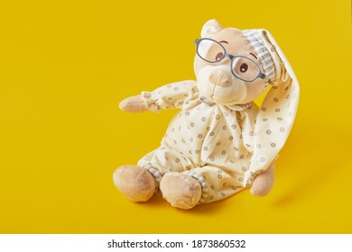 Cute Teddy Bear With Glasses On A Yellow Background, Trend Color, Copy Space, Baby Eye Glasses