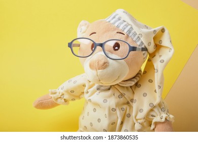 Cute Teddy Bear With Glasses On A Yellow Background, Trend Color, Copy Space, Baby Eye Glasses