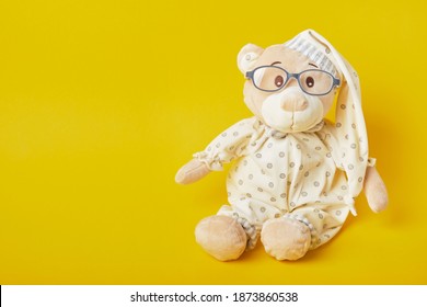 Cute Teddy Bear With Glasses On A Yellow Background, Trend Color, Copy Space, Baby Eye Glasses