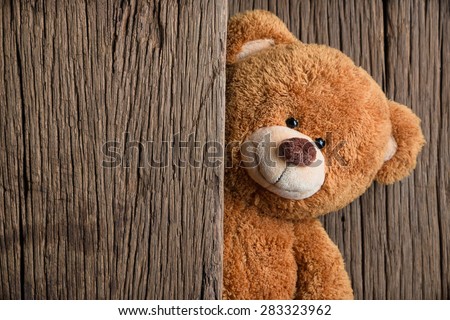 Cute teddy bear with old wood background