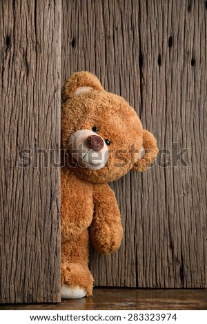 Cute teddy bear with old wood background