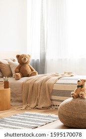 Cute teddy bear on single bed in bright kid's room