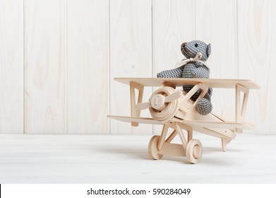 Cute Teddy Bear On Wooden Background With Wooden Baby Toys