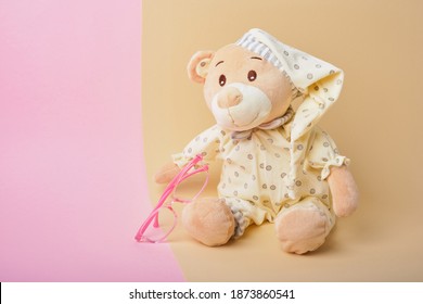 Cute Teddy Bear And Pink Baby Glasses On Beige And Pink Background, Color Trend, Copy Space, Baby Eye Glasses, Children Vision Test Concept