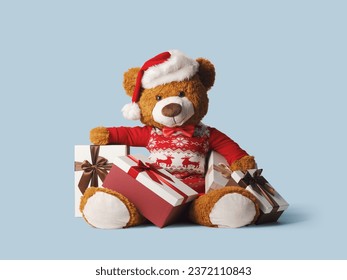 Cute teddy bear wearing a Santa hat and Christmas gifts, holidays and celebrations concept - Powered by Shutterstock