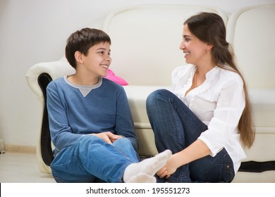 Cute Teen Boy With His Young Mother At Home