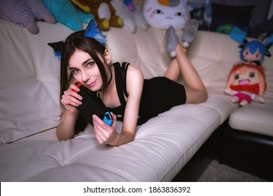 Cute Teen Cosplay Girl Gamer Playing Console At Home At Night