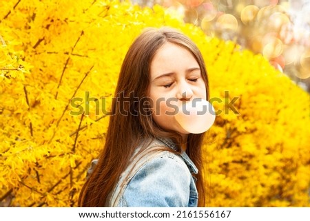 Similar – Image, Stock Photo Young teenage girl blowing pink bubble gum