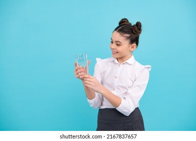 Cute Teen Girl Drinking Water From Glass On Blue Background. Happy Teenager, Positive And Smiling Emotions Of Teen Girl.