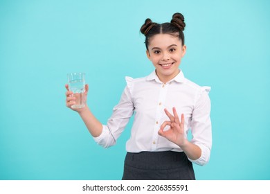 Cute Teen Girl Drinking Water From Glass On Blue Background. Happy Teenager, Positive And Smiling Emotions Of Teen Girl.