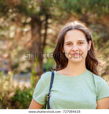 A Cute Teen Girl Looks Into The Camera And Smiles Outdoors Portrait Of A A Cute Teen Girl Looks Into The Camera And Smiles Outdoors Portrait Of A
