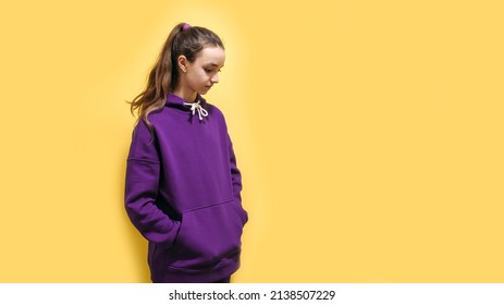 Cute Teen Girl In A Purple Hoodie. Kids Hoodies Mockup. Studio Shot On Yellow Background.