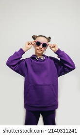 Cute Teen Girl In A Purple Hoodie. Kids Hoodies Mockup. Studio Shot On White Background.