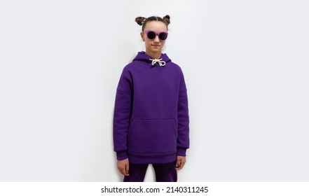 Cute Teen Girl In A Purple Hoodie. Kids Hoodies Mockup. Studio Shot On White Background.