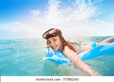 Cute Teen Girl Snorkeling On Matrass In The Sea