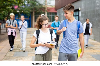 Cute Teen Girl Walking With Her Classmate Outside College Building On Autumn Day, Going To Lessons.