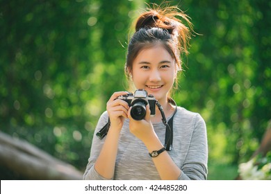 Cute Teenage Asian Girl With Camera Outdoor (selective Focus)