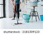 cute teenage boy do household chores, men housework, household help in stylish kitchen in modern apartment, doing laundry and mopping floors, mom