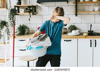 cute teenage boy do household chores, men housework, household help in stylish kitchen in modern apartment, doing laundry and mopping floors, mom's housemate, little helper tired