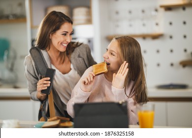 Cute Teenage Girl And Her Smiling Mother Is Greet Each Other At Her Home While Mom Getting Ready To Go To Work.