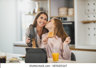 Cute teenage girl and her smiling mother is greet each other at her home while mom getting ready to go to work. - Powered by Shutterstock