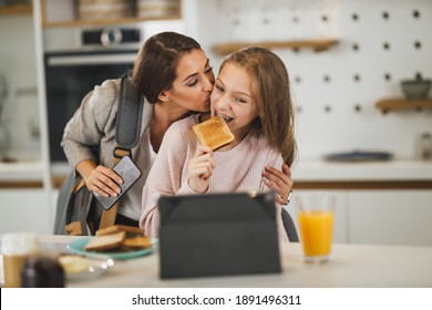 Cute Teenage Girl And Her Smiling Mother Is Greet Each Other At Her Home While Mom Getting Ready To Go To Work.