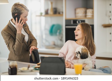 Cute Teenage Girl And Her Smiling Mother Is Greet Each Other At Her Home While Mom Getting Ready To Go To Work.