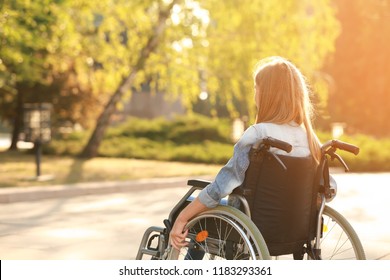 Cute teenage girl in wheelchair outdoors - Powered by Shutterstock