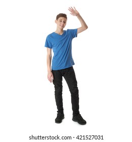 Cute Teenager Boy In Blue T-shirt Standing And Greeting Over White Isolated Background Full Body Waving Hand