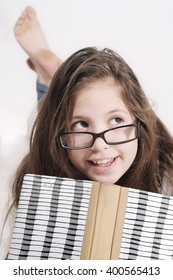 Cute Teenager Girl Laying On The Floor And Reading A Book At Home