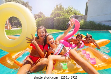 Cute Teens Playing With Swimming Floats In Pool