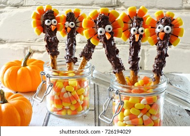 Cute Thanksgiving Turkey Pretzel Sticks With Candy Corn, Still Life Against A White Brick Background