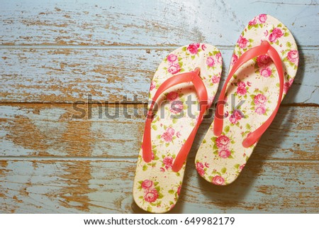 Cute thongs with rosette on the wooden floor