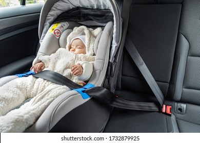 Cute Three Months Old Baby Sleeping In Car Seat On Back-seat Of The Car