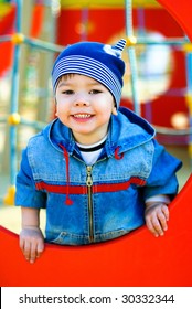 Cute Three Year Old Boy Playing Outdoor At The Children's Playground