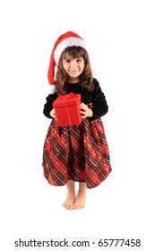 Cute Three Year Old Little Girl Dressed Up In A Fancy Dress And Christmas Hat Holding A Red Giftbox Standing Barefoot On A White Background