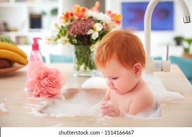 Cute Tiny Baby Girl Taking A Bubble Bath In A Kitchen Sink