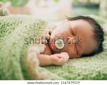 Cute tiny kid napping peacefully in his bad