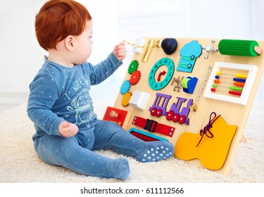 Cute Toddler Baby Playing With Busy Board At Home