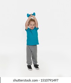 Cute Toddler Boy In Blue Shirt And Sweat Pants Exercising With Hands Weight Isolated On White Background